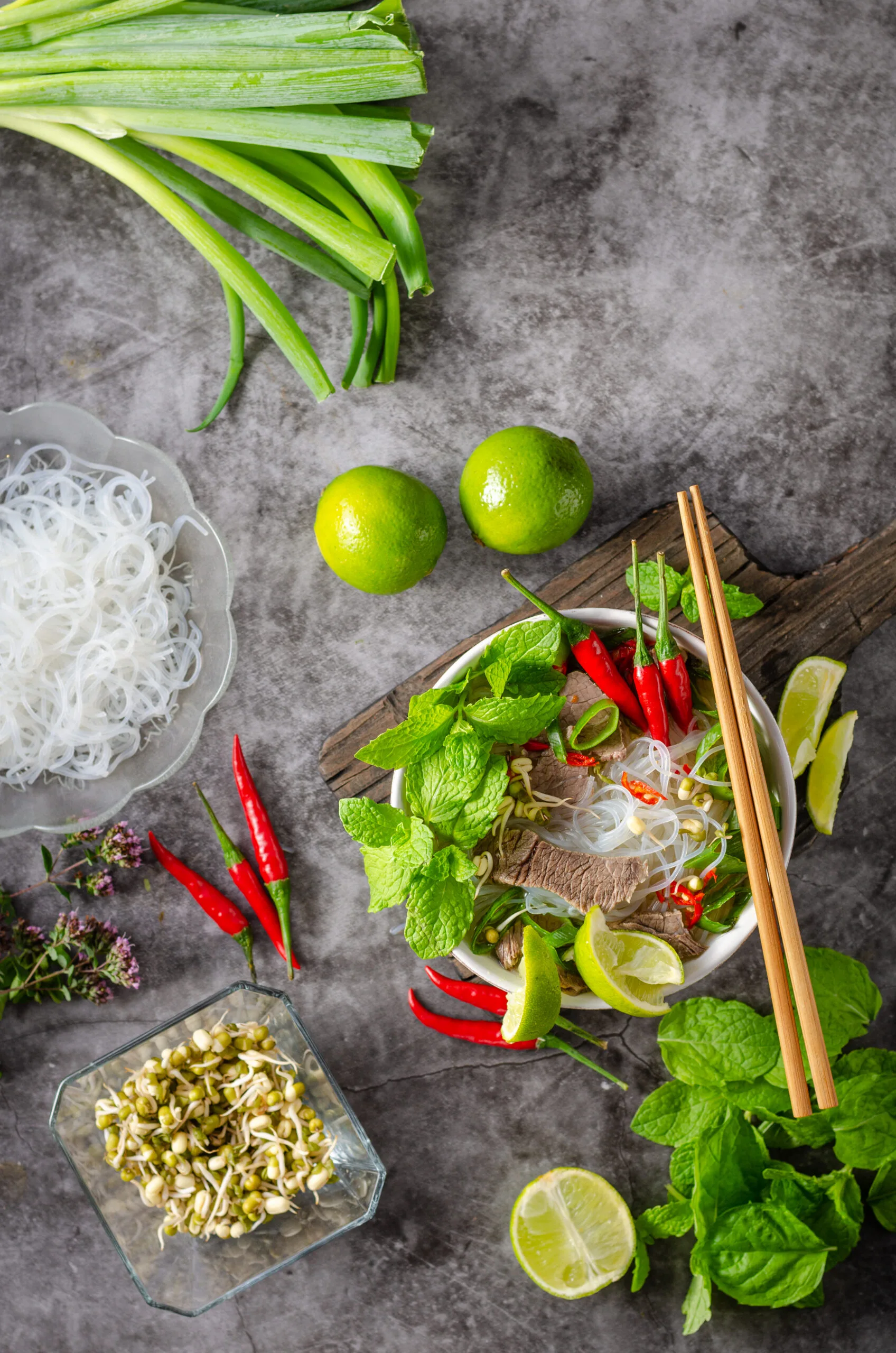 Traditional Vietnamese soup with chilli, noodles, fresh herbs and beef meat